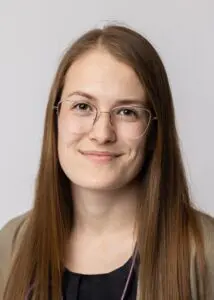 A woman with glasses and long hair.