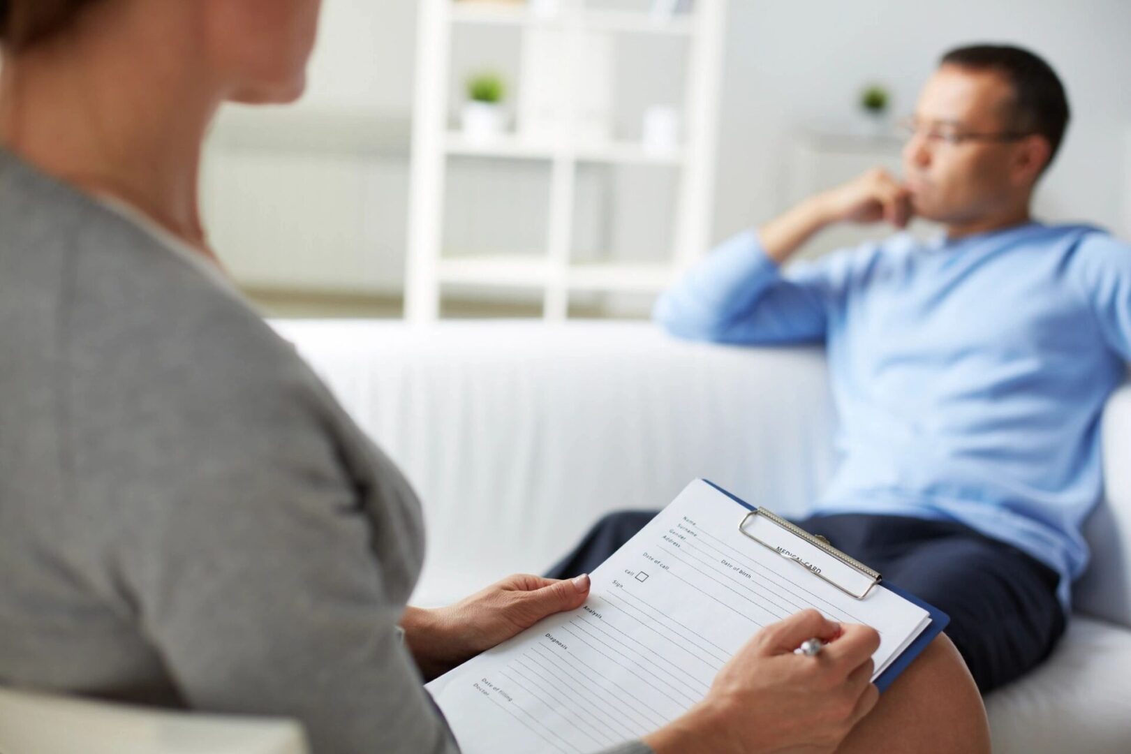 Therapist taking notes during a session.