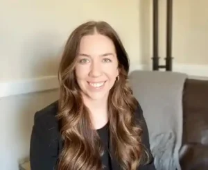 Smiling woman with long brown hair.