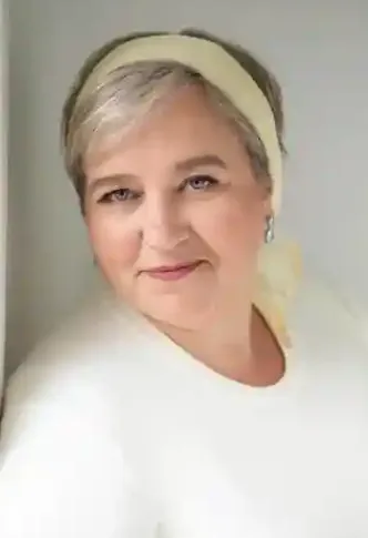 Woman with gray hair wearing a headband.