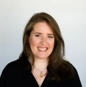 Smiling woman with long brown hair.