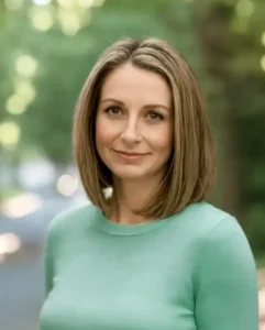 Woman with brown hair and a green shirt.