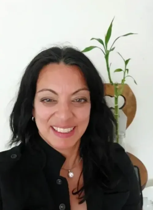 Woman with black hair smiling at camera.