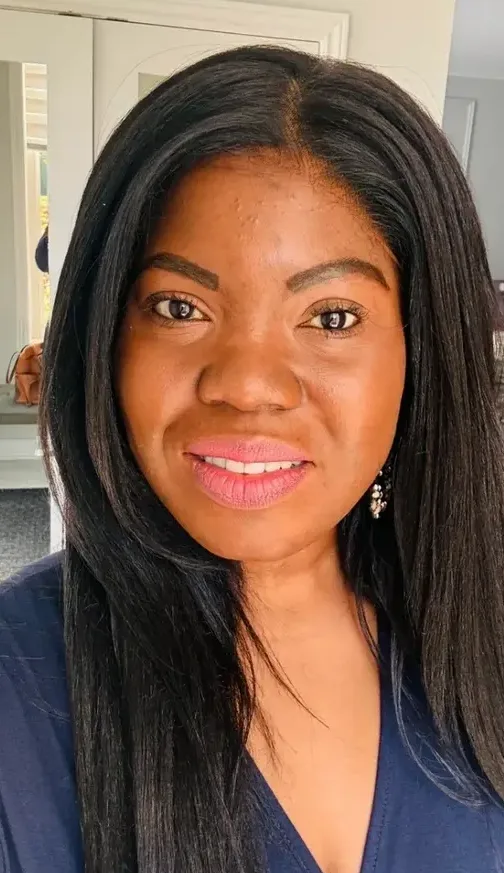 Woman with long black hair smiling.