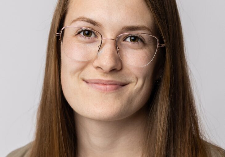 A woman with glasses and long hair.