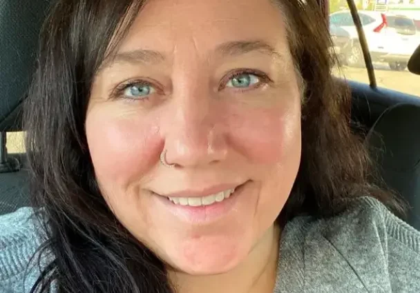 Jennifer Grant (Jobin) Woman with long dark hair smiling in a car.
