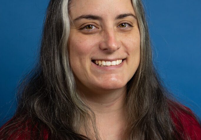 Michelle N 2024 Smiling woman with long graying hair.