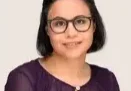 Headshot of a woman wearing glasses.