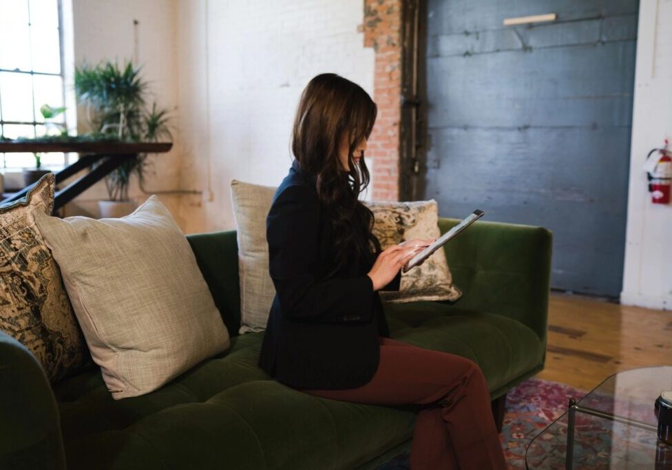 Woman in a blazer working on a tablet.