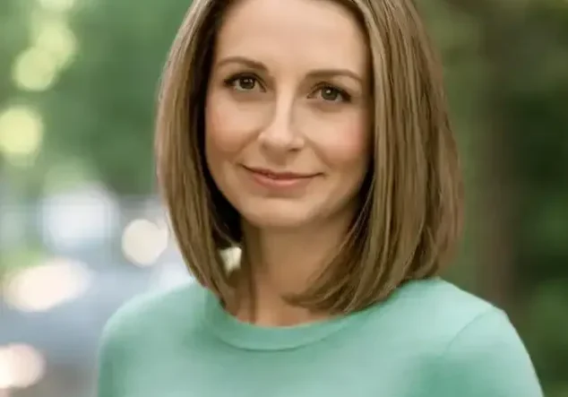Woman with brown hair and a green shirt.