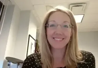 qt=q_60 (2) (1) Woman with glasses smiling in office