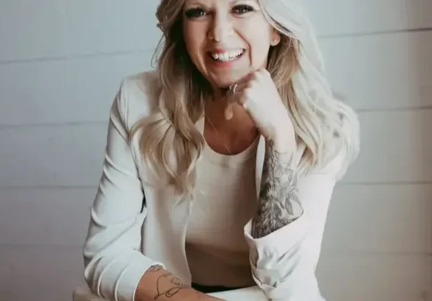 qt=q_74 (1) Smiling woman with a tattoo sitting on a chair.
